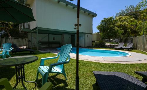 a patio with chairs and a table and a pool at BIG4 Wangaratta North Cedars Holiday Park in Wangaratta