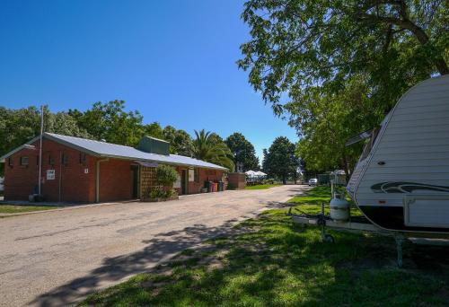 a rv parked next to a building and a road at BIG4 Wangaratta North Cedars Holiday Park in Wangaratta