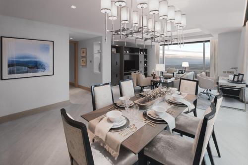 a dining room and living room with a table and chairs at Shangri-La Residences The Fort, Manila in Manila