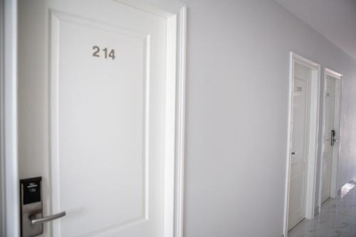 a door with the number on it in a hallway at Rich8 Hostel in Bangkok
