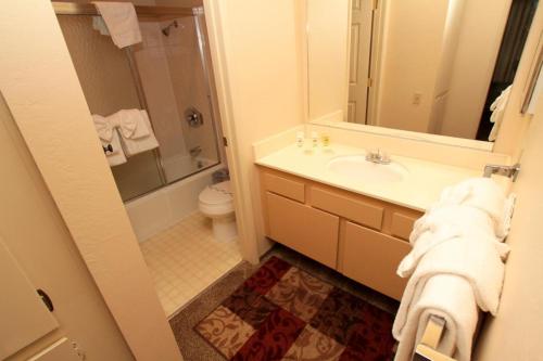 a bathroom with a sink and a toilet and a mirror at Discovery 4 #125 in Mammoth Lakes
