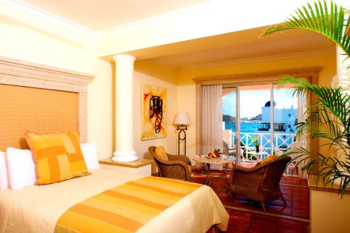 a hotel room with a bed and a table and a window at Pueblo Bonito Rose Resort & Spa - All Inclusive in Cabo San Lucas