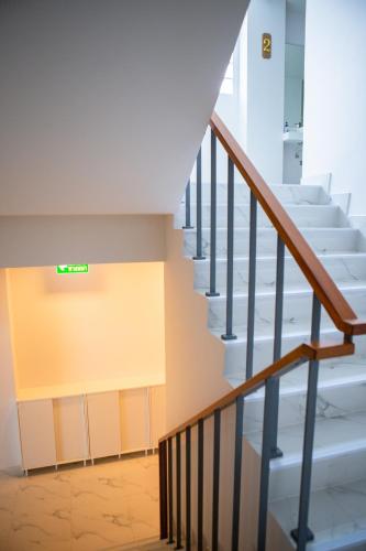 a staircase in a building with a sign on the wall at Rich8 Hostel in Bangkok