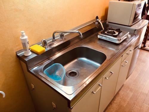 a stainless steel sink in a kitchen at Nishijin Ivy in Kyoto