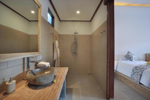 a bathroom with a sink and a shower at Batu Agung Villa Ubud in Ubud