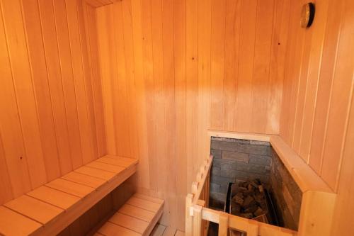 a corner of a sauna with a fireplace in it at LAKE TOYA Logde SIGRA in Lake Toya