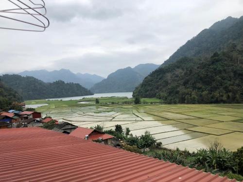 a view of a valley with rice fields and mountains at Ba Be Lake View Homestay in An Ma