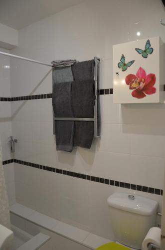 a bathroom with a toilet and towels on a wall at FAME - Marina baie des Anges in Villeneuve-Loubet