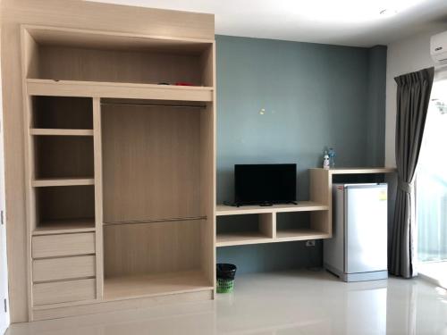 a living room with a built in book shelf at Khao Oat airport in Nai Yang Beach
