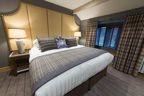a bedroom with a large bed and a window at Fence Gate Lodge in Burnley