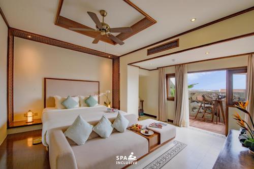 a bedroom with a bed and a living room at Almanity Hoi An Resort & Spa in Hoi An