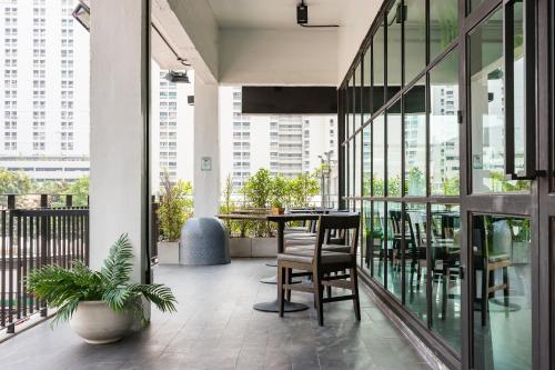 a balcony with a table and chairs in a building at Marwin Villa in Bangkok