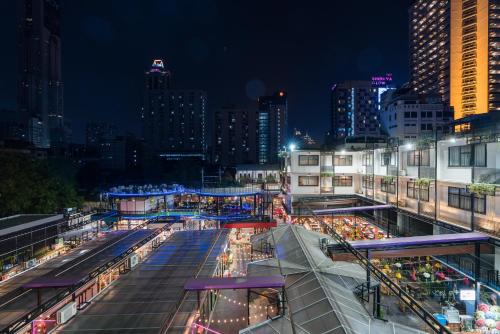 a city lit up at night with lit up buildings at Marwin Villa in Bangkok