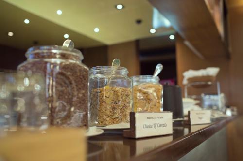 a group of jars of food on a counter at Emerald Palace Hotel in Nay Pyi Taw