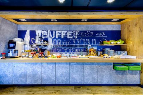 a kitchen with a counter with food on it at ibis budget Dueren West in Düren - Eifel