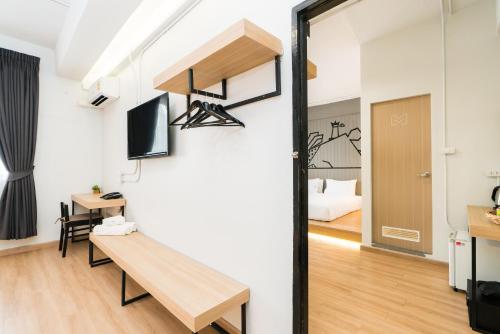 a room with a bench and a room with a bed at Marwin Villa in Bangkok