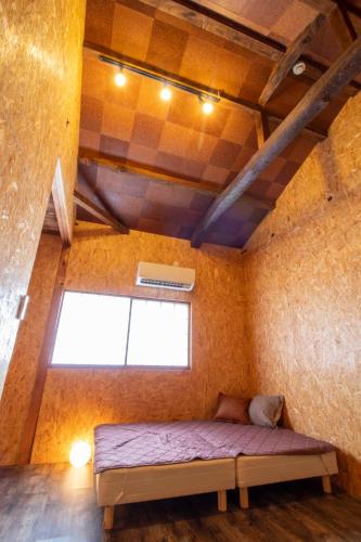 a bedroom with a bed in a room with a window at CRAFT in Matsubara