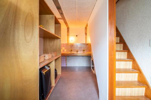 a small kitchen with a staircase in a house at CRAFT in Matsubara