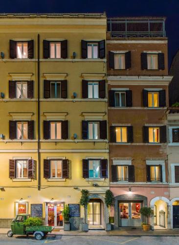 a building with a green car parked in front of it at Condominio Monti Boutique Hotel in Rome