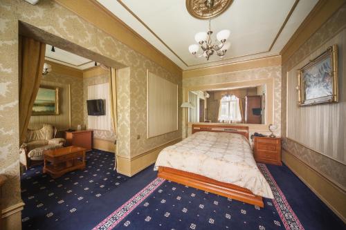 a bedroom with a bed and a living room at Ukraina Hotel in Simferopol
