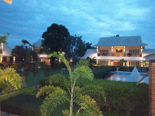 a large house with a pool in front of it at Scent of Sukhothai Resort in Sukhothai