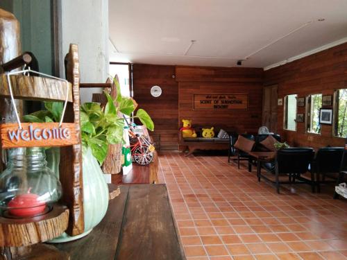 a lobby with a room with a table and chairs at Scent of Sukhothai Resort in Sukhothai