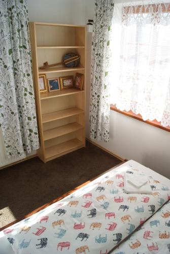 a bedroom with a bed and a window at Przybobrze Apt. in Jelenia Góra