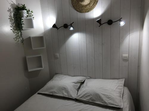 a room with a bed with lights on the wall at Les Restanques du Golfe de saint Tropez in Grimaud