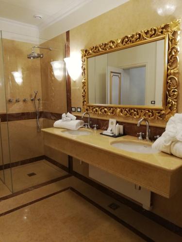 a bathroom with a mirror and a sink and a shower at Ca' Bonfadini Historic Experience in Venice
