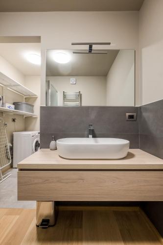 a bathroom with a sink and a large mirror at Aparthotel Sant'Orsola in Bologna