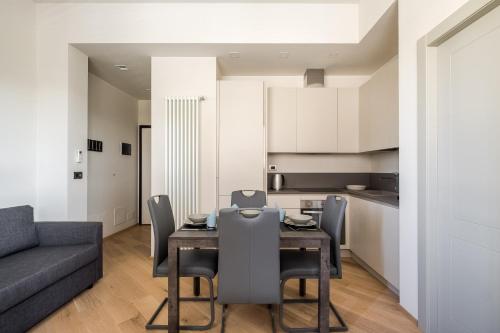 a dining room with a table and a couch at Aparthotel Sant'Orsola in Bologna