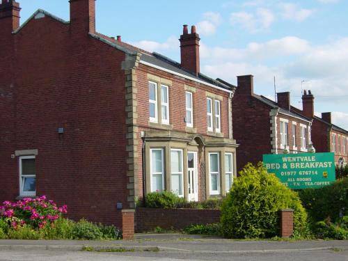 a brick building with a sign in front of it at Wentvale in Knottingly