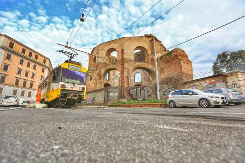 a train on the tracks in front of a building at Hotel Giolitti in Rome