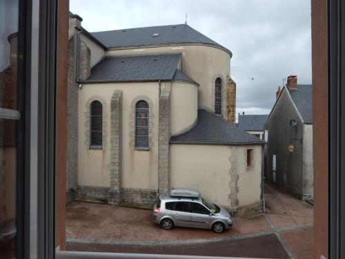 a car parked in front of a church at Le Lion D'or in Ouroux en Morvan