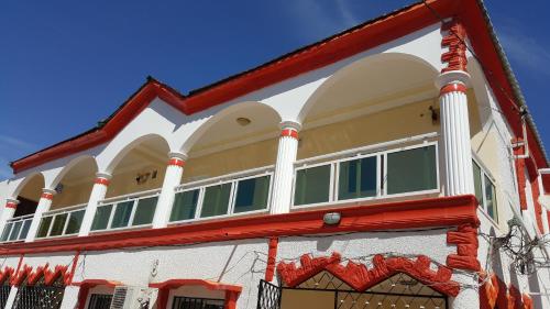 a building with a red and white at Ous and Buwa in Yundum