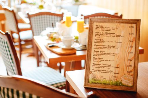 a menu on a table in a restaurant at Pension Dorfliebe in Sondershausen