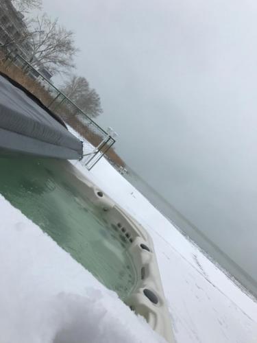 a snow covered roof of a house with a bath tub at Royal Mediterran in Siófok