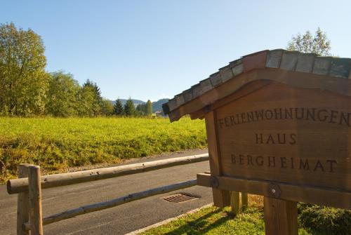 a sign on the side of a road next to a field at Haus Bergheimat in Abtenau