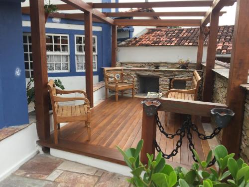 an outdoor deck with a fireplace on a house at Hotel Pousada Casa Grande in Ouro Preto