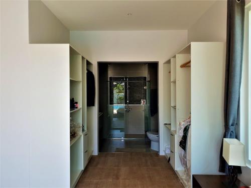 a bathroom with a toilet and a walk in shower at Villa de Veluwe @ Hua Hin in Hua Hin