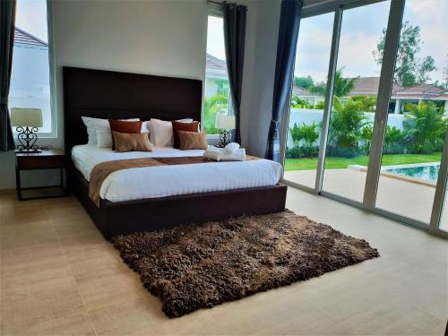 מיטה או מיטות בחדר ב-Villa de Veluwe @ Hua Hin