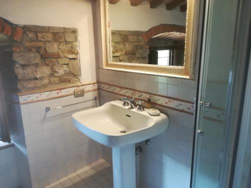 a bathroom with a sink and a mirror at Villa Migliorati in Vaiano