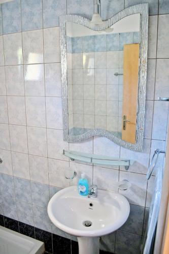 a bathroom with a sink and a mirror at Villa Nina in Skala Rachoniou