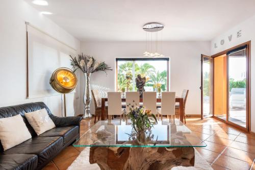 a living room with a table and a couch at Serena Villa in Ibiza Town
