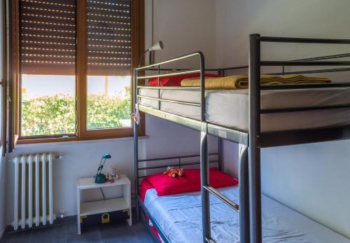 a bedroom with two bunk beds and a window at Tuscany By The Sea in Tirrenia