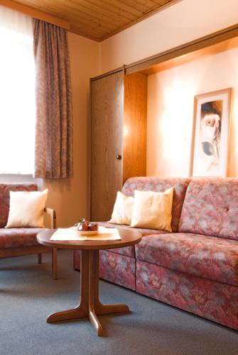 a living room with a couch and a table at Haus Bergheimat in Abtenau