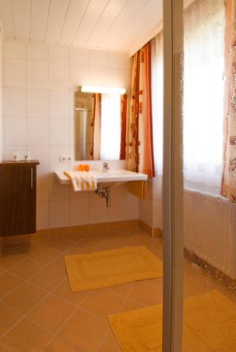 a bathroom with a sink and a mirror at Haus Bergheimat in Abtenau