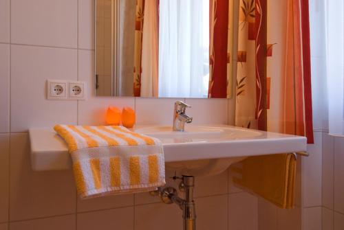 a bathroom with a sink and a mirror at Haus Bergheimat in Abtenau