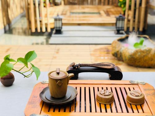 a table with a coffee cup and a phone on it at Dali Liao Fan Seaview Villa in Dali