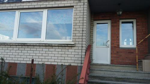 a house with two windows and a white door at Valjotė in Tauragė